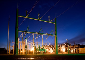 green and grey transmission tower during nighttime