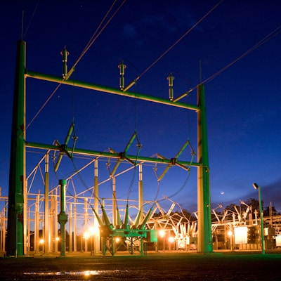 green and grey transmission tower during nighttime