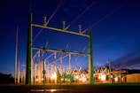 green and grey transmission tower during nighttime
