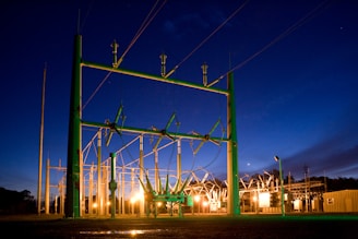 green and grey transmission tower during nighttime