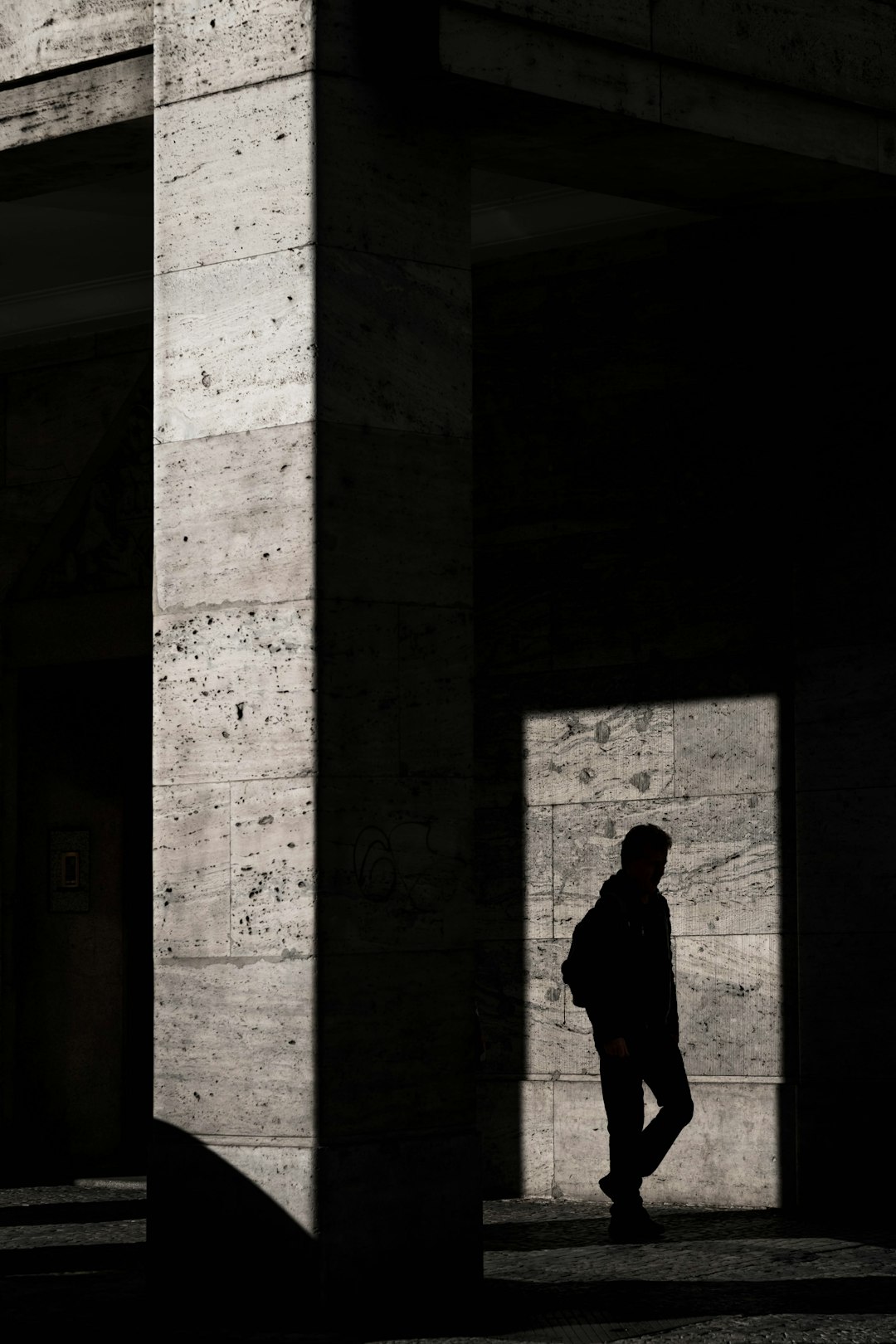 silhouette of man standing inside structure