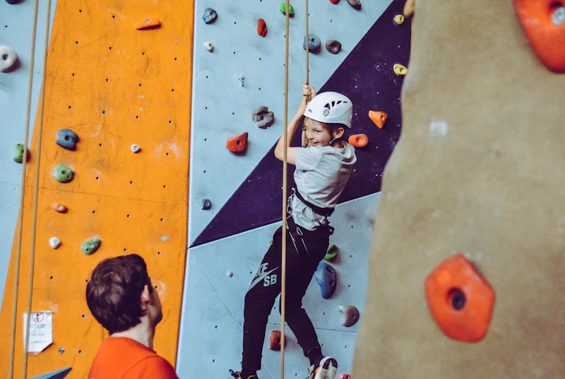 Kid climbing an indoor bouldering wall
