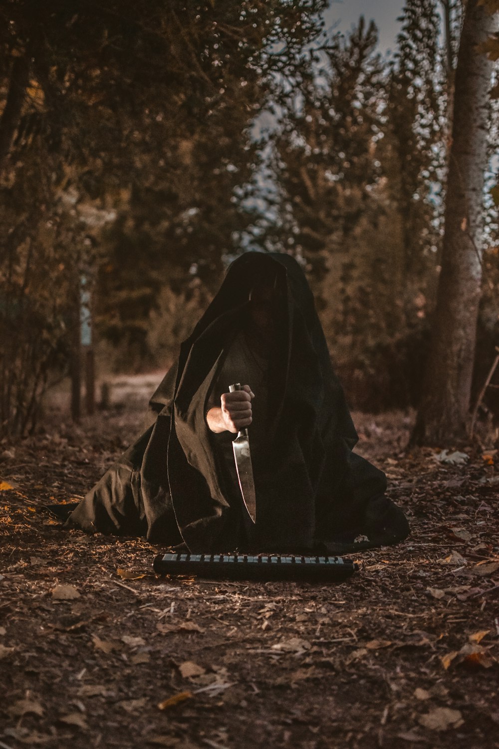 person holding knife with black textile cover