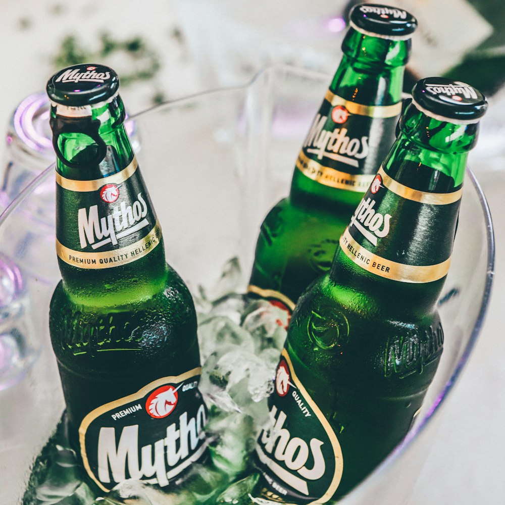 three green beer glass bottles