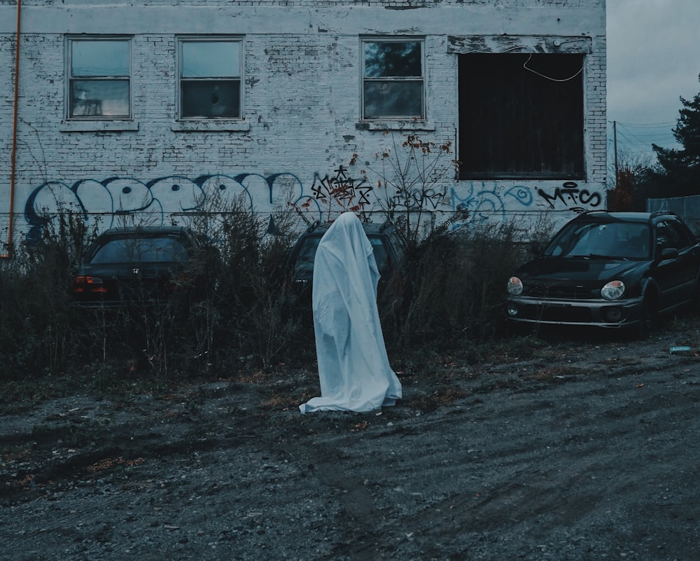 person standing in front of concrete building