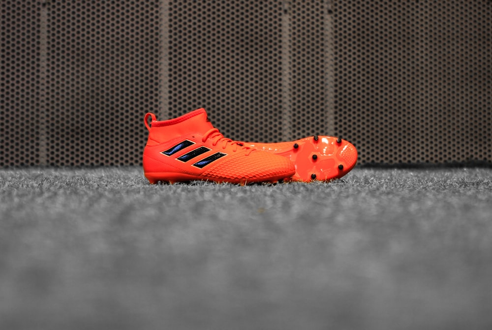 pair of red adidas cleats
