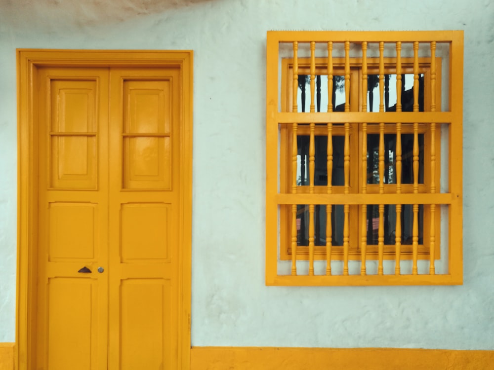 yellow 8-panel door beside window