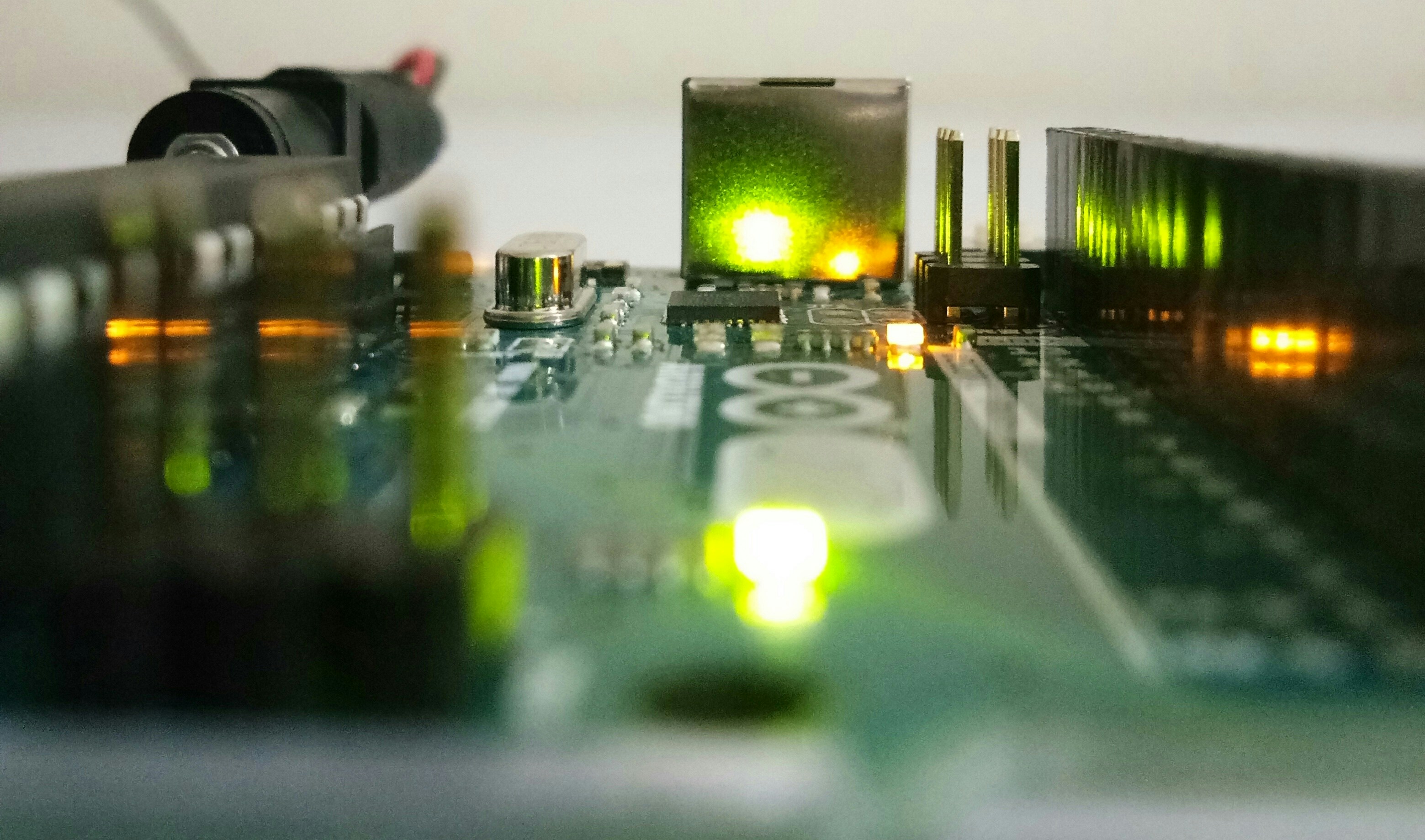 Well-lit circuit board with bright LED indicators, clean white background, technical precision
