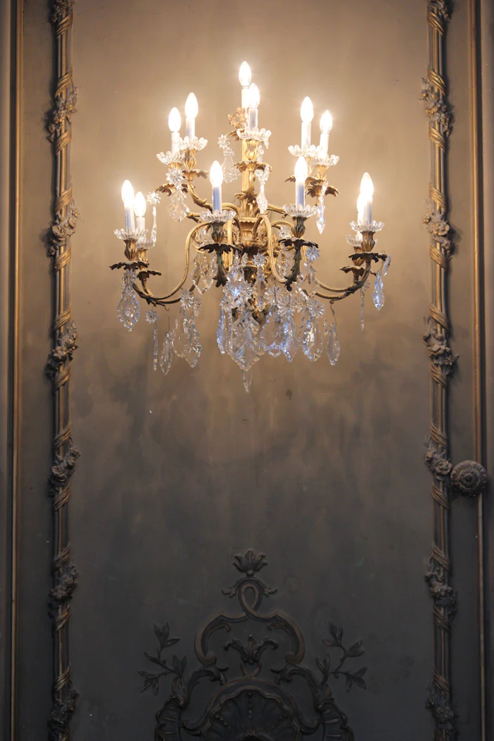 Chandelier-lit château ballroom set for a reception