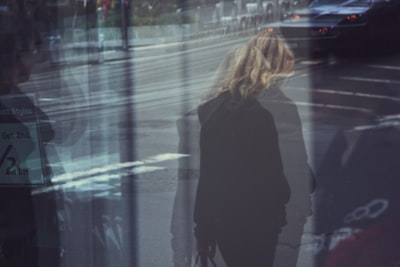 person wearing black jacket blurred google meet background