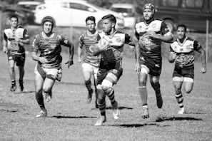 Players passing a rugby ball in an outdoor training session.