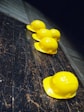 five yellow hard hats on gray surface