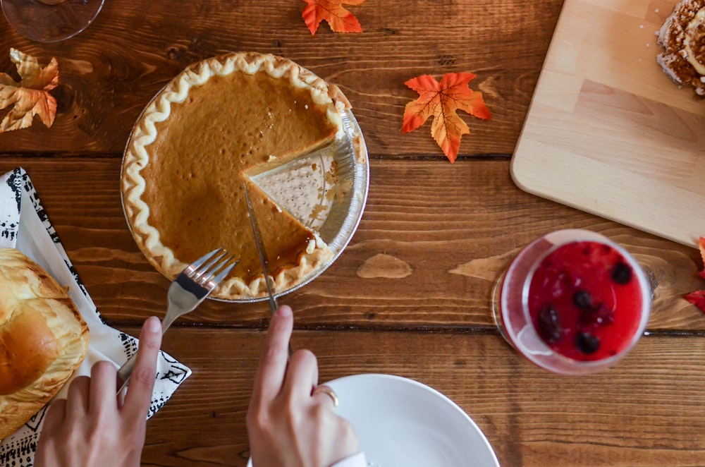 person holding table knife about to slice pancake