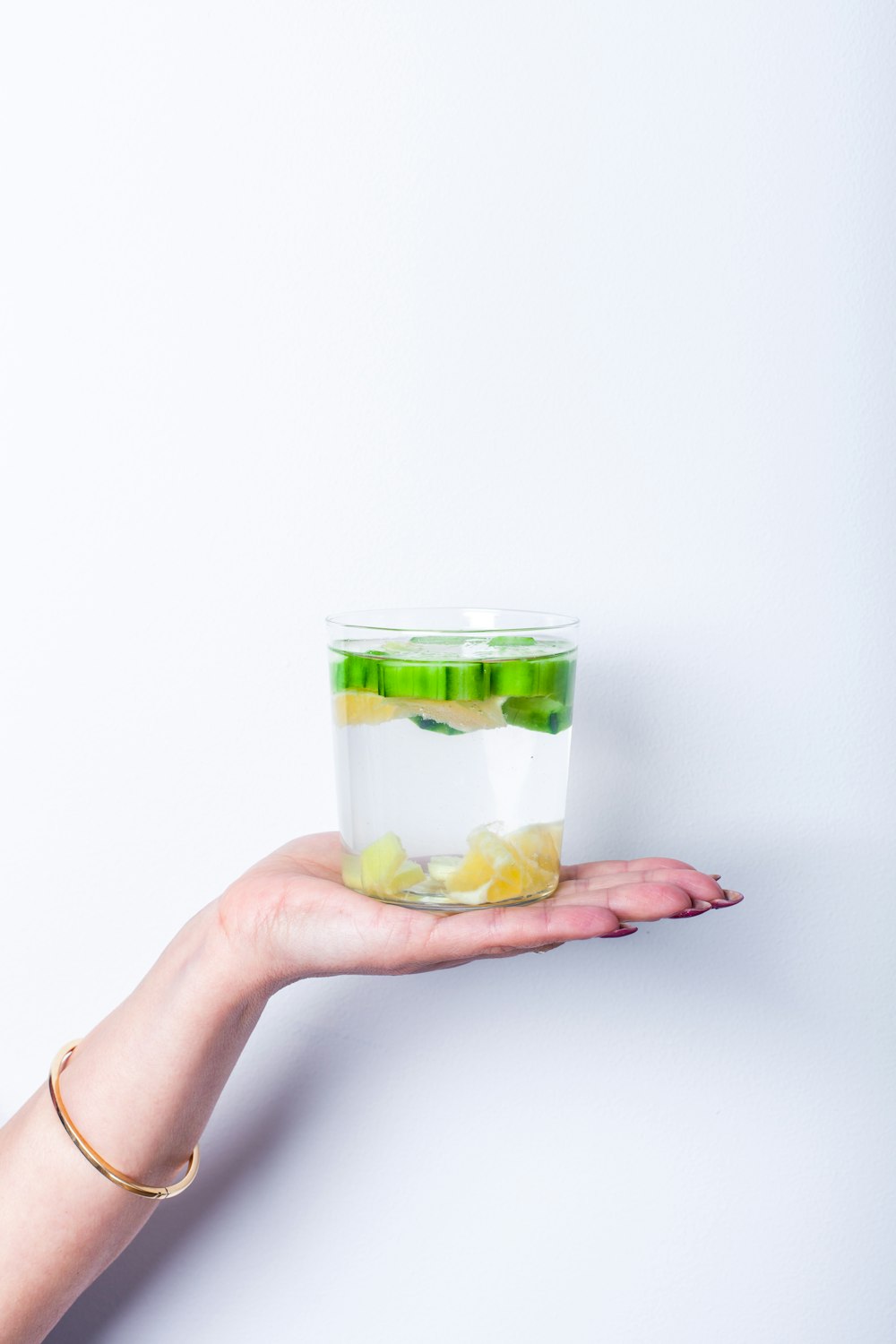 a person holding a small container of food