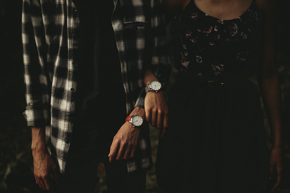 man and woman standing while holding hands