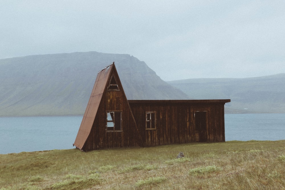 brown wooden house near lake