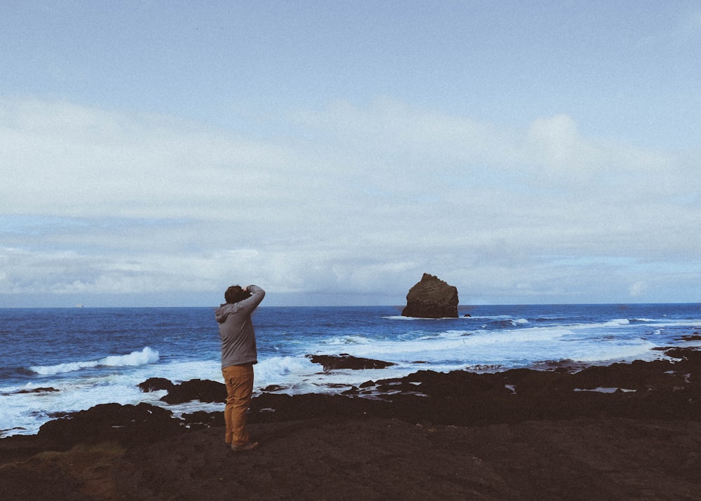 man standing near beach