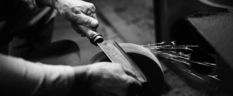 person grinding cleaver