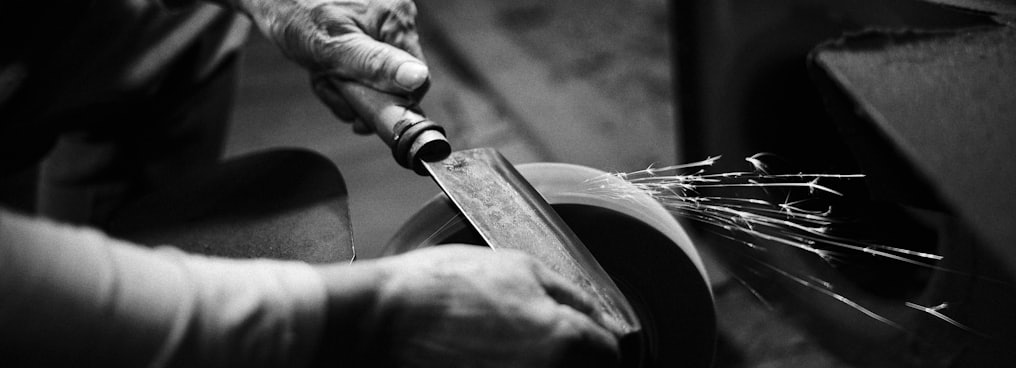 person grinding cleaver