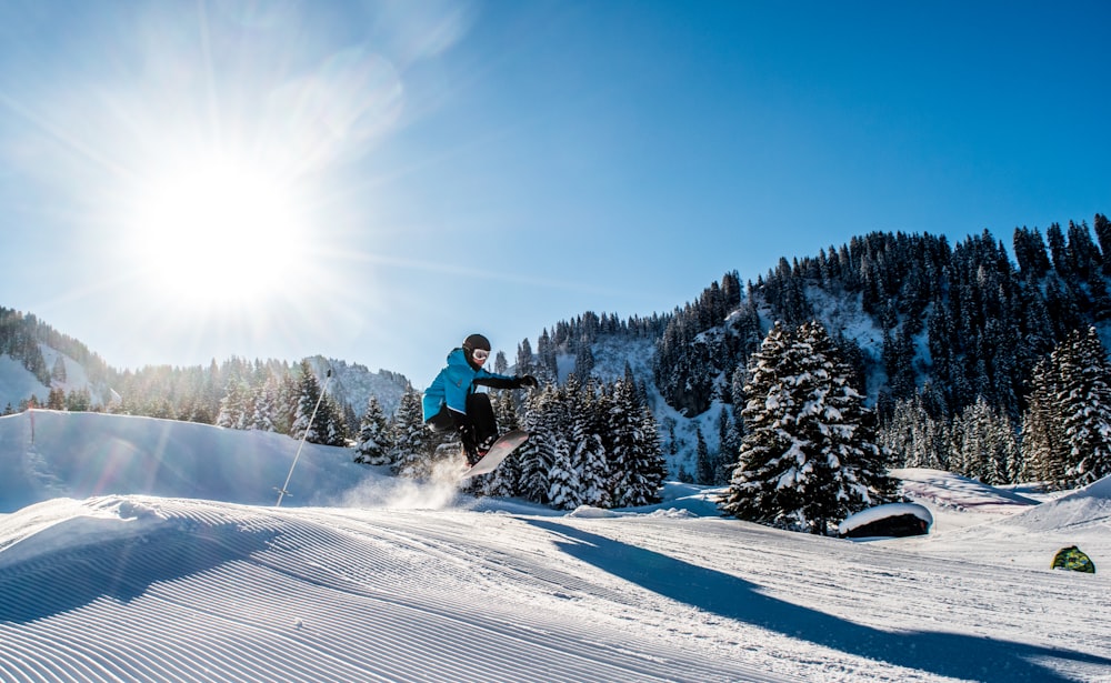 person on snowboard in distant of trees