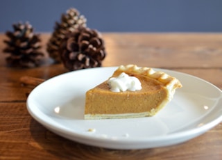 closeup photo of sliced pie on white ceramic saucer