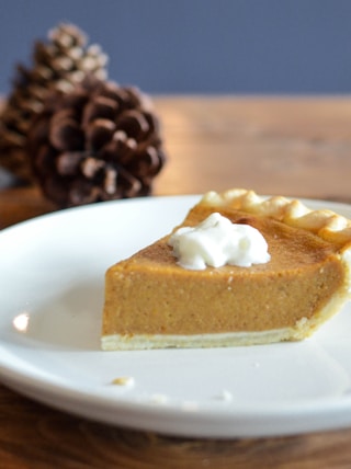 closeup photo of sliced pie on white ceramic saucer