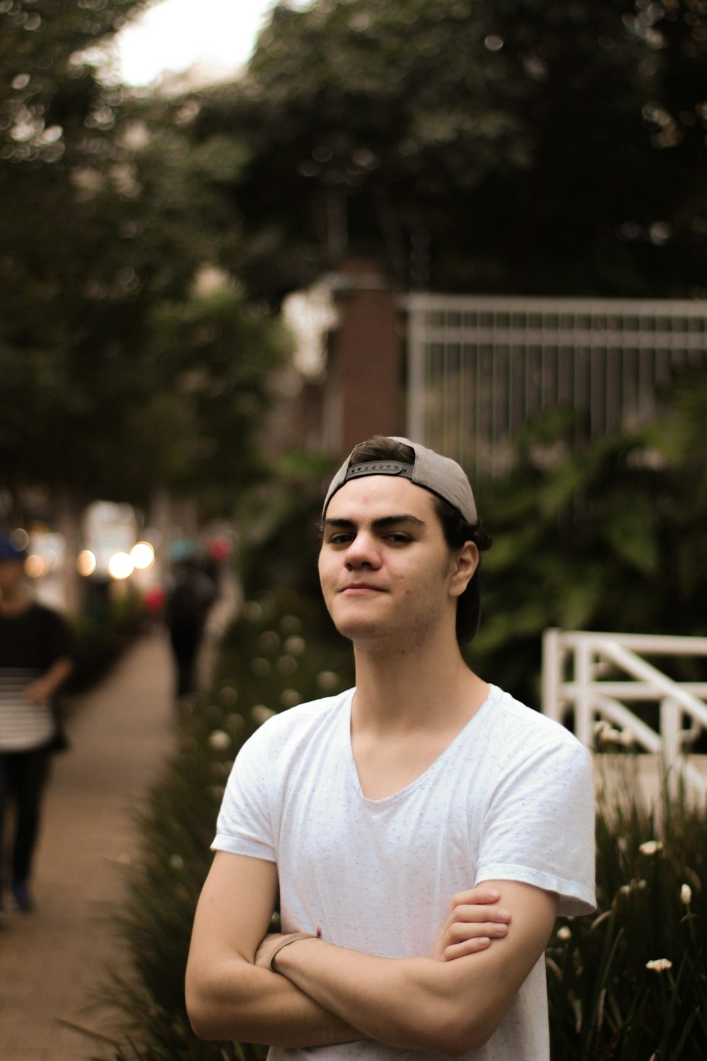 selective focus photograph of man wearing white scoop-neck t-shirt