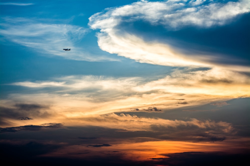 low-angle photography of airplane on golden hour