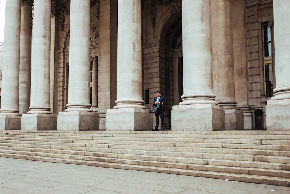 man standing in the middle of pillar building