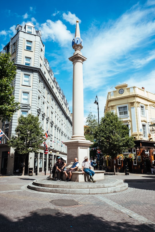 people sits on concrete tower in Seven Dials United Kingdom