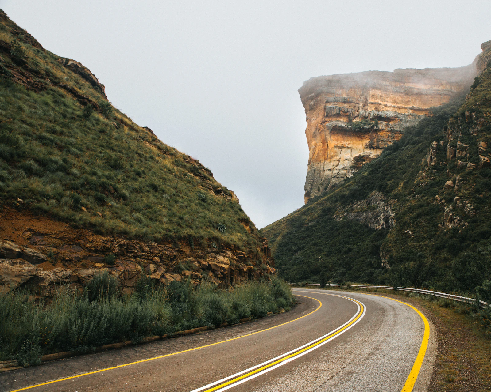 South African highway running between steep mountain slopes