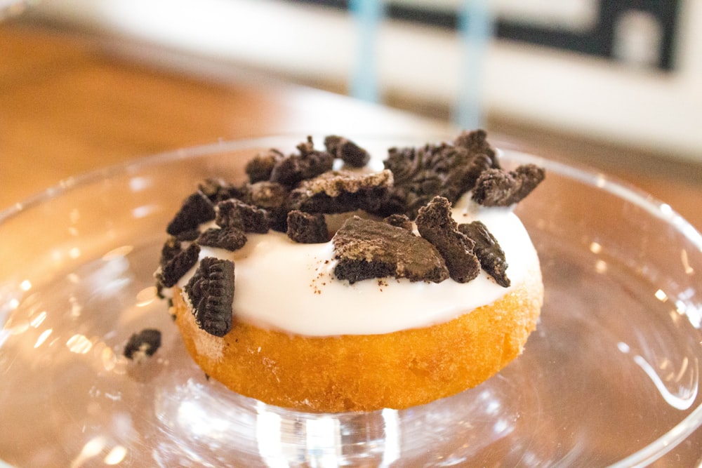 chocolate toppings donut on clear glass tray