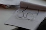 black framed eyeglasses on top of white printing paper