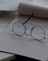 black framed eyeglasses on top of white printing paper