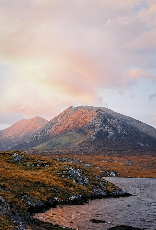 brown and gray mountain under blue sky in Connemara National Park Ireland