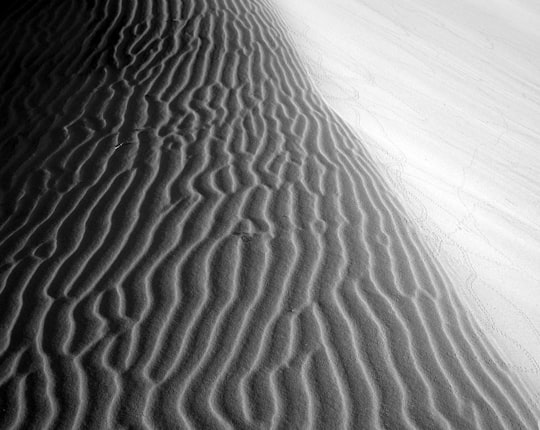 greyscale photo of desert in Kelso Dunes United States