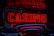 Neon lights display the word 'CASINO' in bright red, standing out against a dark background. The vibrant glow reflects a lively and bustling atmosphere.