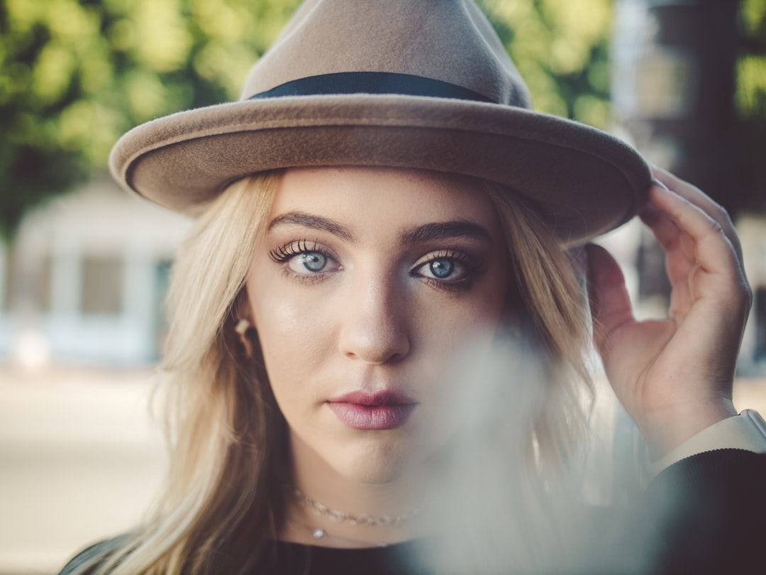 selective focus photography of woman wearing brown hat and black top