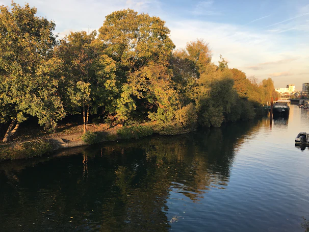 A serene riverside spa experience surrounded by lush greenery at golden hour.