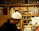 A cozy restaurant kitchen with vibrant product labels being applied on jars.