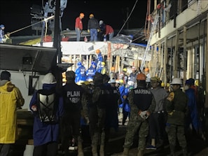 Emergency response team arriving at a flood-damaged property at night