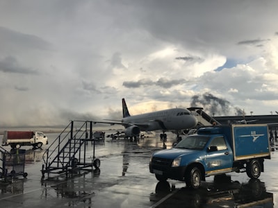 Aircraft on runway with Brooksplanck service vehicle nearby