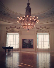 An elegant exhibition room with framed portraits and musical instruments.