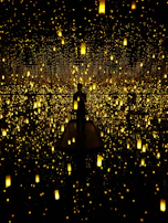 A fine art installation glowing softly under string lights, inviting quiet reflection.