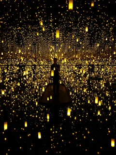 A fine art installation glowing softly under string lights, inviting quiet reflection.