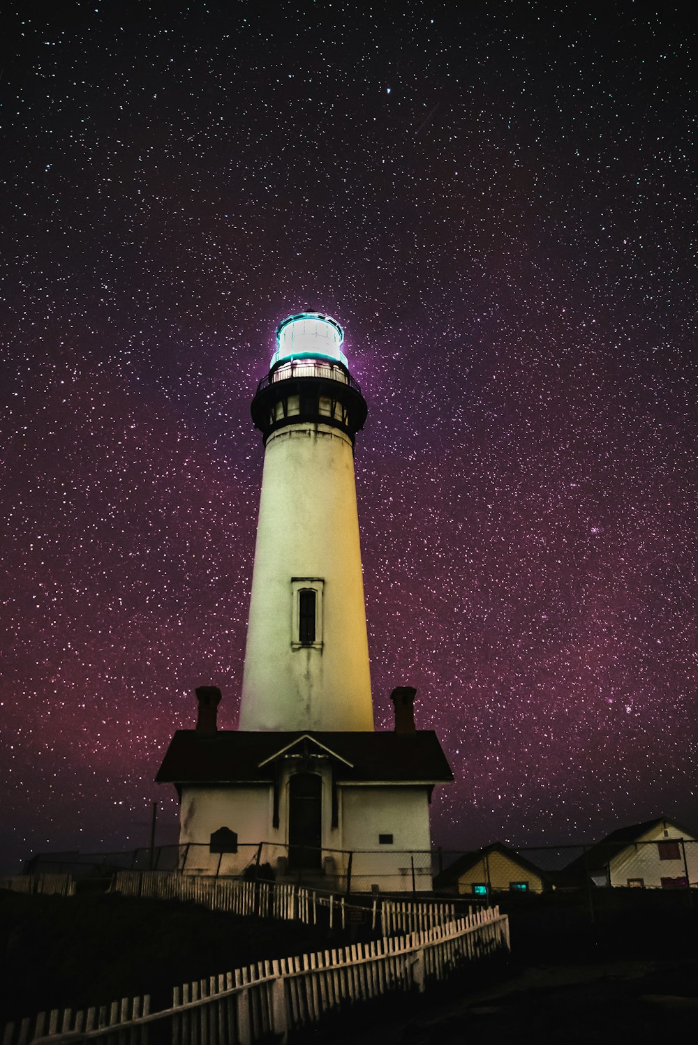 white lighthouse under starry night