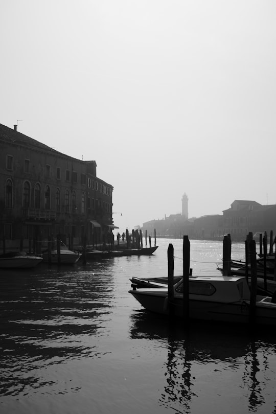 gray scale photo of boat in Murano Italy
