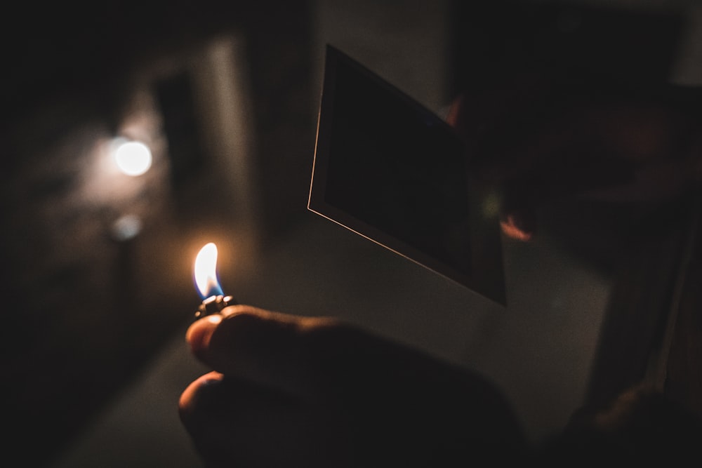 Flachfokusfotografie einer Person, die ein Feuerzeug hält