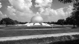 A vast dome sheltering a large agricultural field under a bright sky.