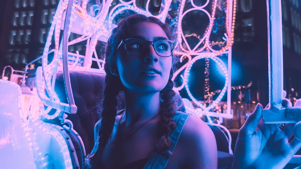 woman wearing black framed eyeglasses riding amusement park ride